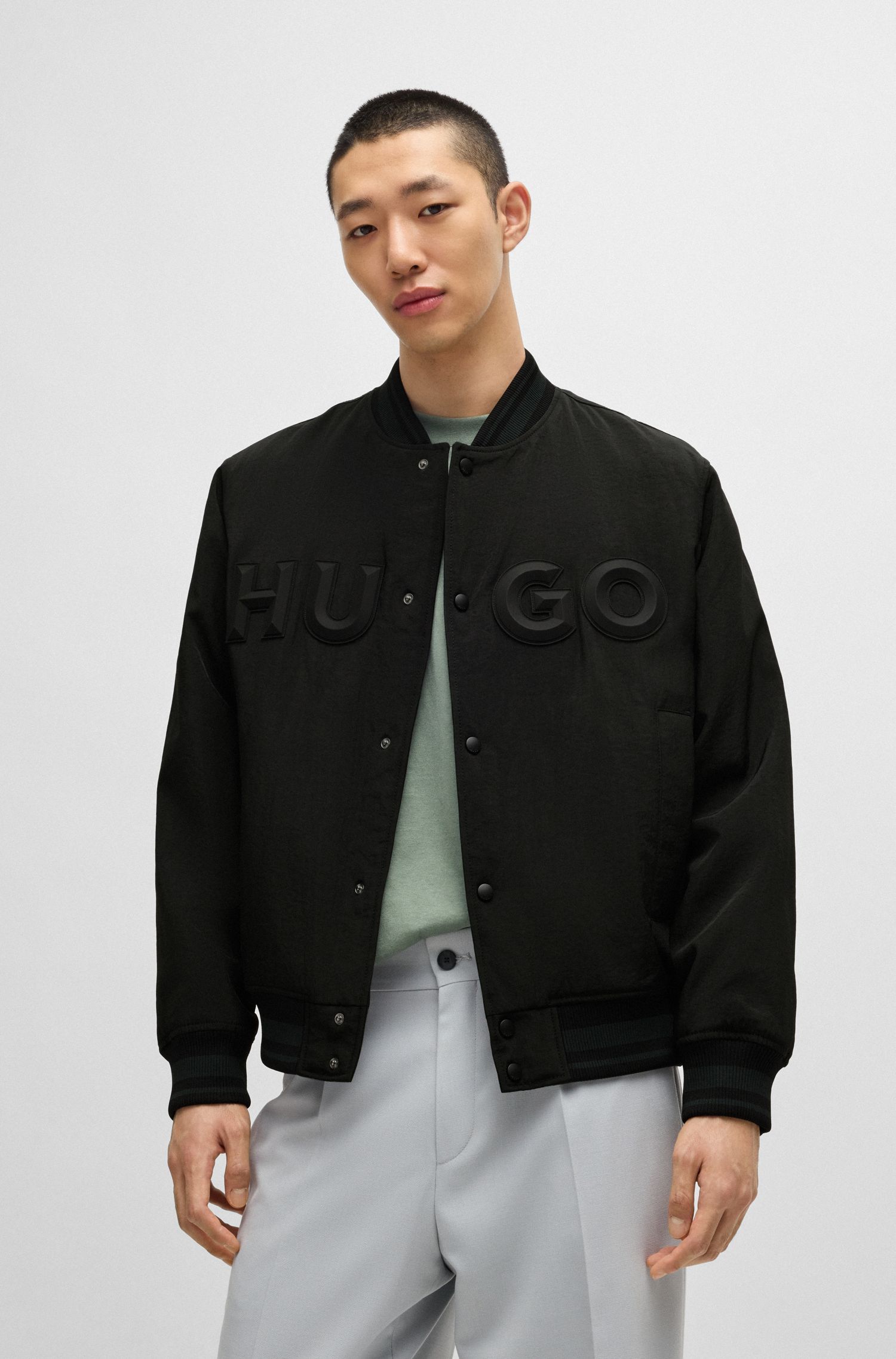 Áo khoác bomber dáng relaxed vải canvas chống nước in logo cao su