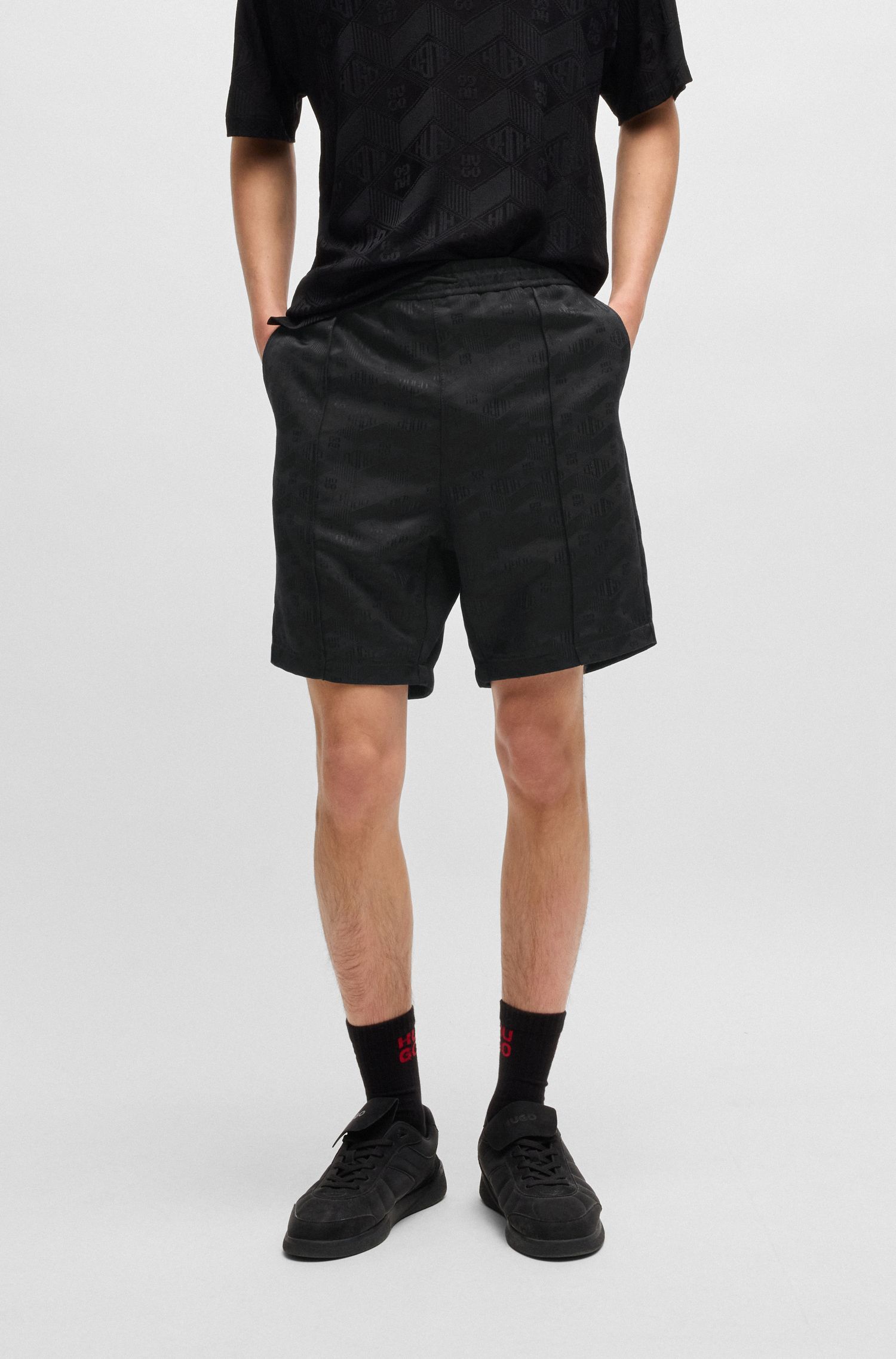 Quần shorts dáng relaxed in logo hình học